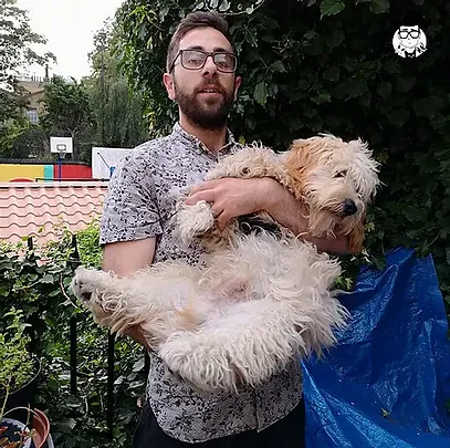 Photo of Ben holding a dog
